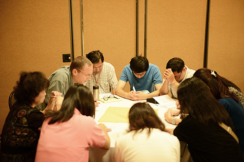 Students praying together at Logos Evangelical Seminary
